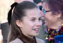 William beams with pride as he watches Charlotte greet well-wishers