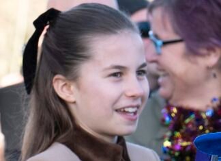 William beams with pride as he watches Charlotte greet well-wishers
