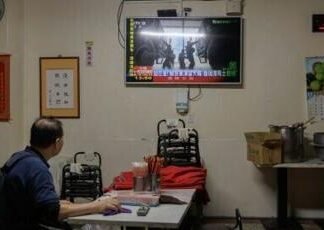 A man in Taiwan watches TV news coverage of the Chinese People’s Liberation Army military drills this week, which Taipei called ‘highly provocative’