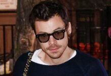 Harry Styles rocks a leopard print handbag and shades as he heads out for Saturday Night Live cast dinner ahead of hosting the show