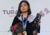 What does GM Bibisara Assaubayeva carry in her champion handbag?