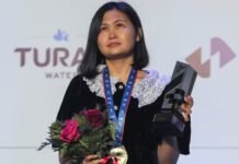 What does GM Bibisara Assaubayeva carry in her champion handbag?