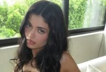 Kylie Jenner strips to her bra on the sofa as she flaunts $1m handbag collection