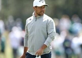 Two-time major winner Xander Schauffele watches at the 15th green during a practice round ahead of the 90th Masters
