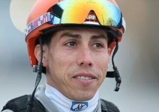 Irad Ortiz Jr., jockey of Kentucky Derby favorite Renegade, watches in the barn area at Churchill Downs after morning workouts ahead of the 152nd Run for the Roses