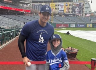 Young fan watches workout in the downpour, gets rewarded by Ohtani himself