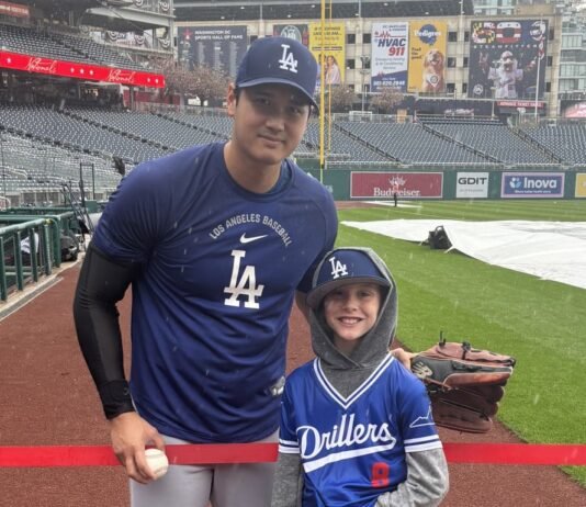 Young fan watches workout in the downpour, gets rewarded by Ohtani himself