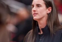 Indiana Fever guard Caitlin Clark (22) watches as her team mates warm up as the Portland Fire face the Indiana Fever Wednesday, May 20, 2026, at the Gainbridge Fieldhouse in Indianapolis.