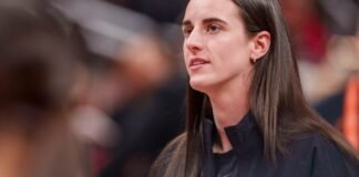 Indiana Fever guard Caitlin Clark (22) watches as her team mates warm up as the Portland Fire face the Indiana Fever Wednesday, May 20, 2026, at the Gainbridge Fieldhouse in Indianapolis.
