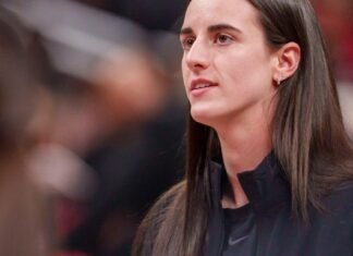 Indiana Fever guard Caitlin Clark (22) watches as her team mates warm up as the Portland Fire face the Indiana Fever Wednesday, May 20, 2026, at the Gainbridge Fieldhouse in Indianapolis.
