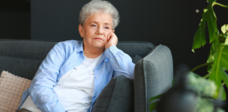 Boomers who watch hours of TV a day are often grieving the specific kind of company a long marriage used to provide — the running commentary of a shared life — and the news anchor who reliably appears at the same hour is the partner who still shows up at the table on time