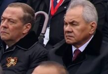 War chief ‘plotting coup against Putin’ frowns as he watches paranoid tyrant’s drastically scaled-back flagship parade
