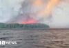 Watch: Residents flee massive Canadian wildfire by boat