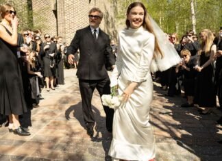 Inside a stylish Stockholm wedding with a brutalist church, bespoke fashion and vintage red shoes